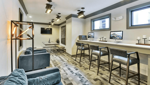 a living room with a bar and a couch